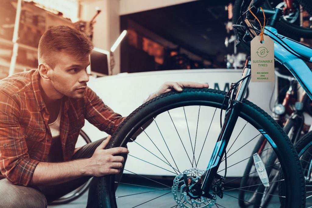 Closeup of Man Examines reTyre Sustainable Bicycle Tyre in Workshop